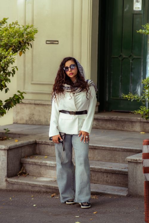 Free Woman in trendy outfit poses outdoors in Tehran, showcasing urban street fashion. Stock Photo