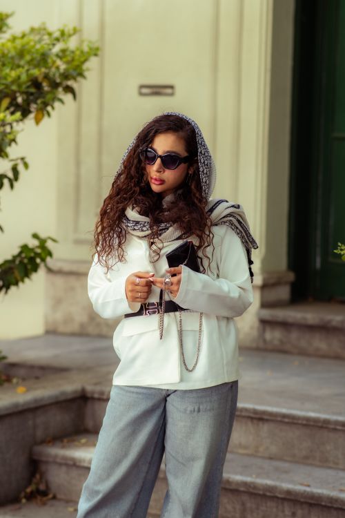 Free Elegant woman in sunglasses stands outdoors in Tehran, showcasing modern fashion style. Stock Photo