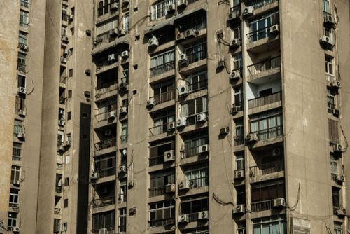 Free Close-up of a high-rise apartment building in Cairo, Egypt with numerous air conditioners on the facade. Stock Photo
