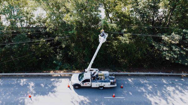 Utility bucket truck servicing overhead lines