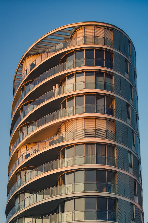 Modern curved glass building at sunset