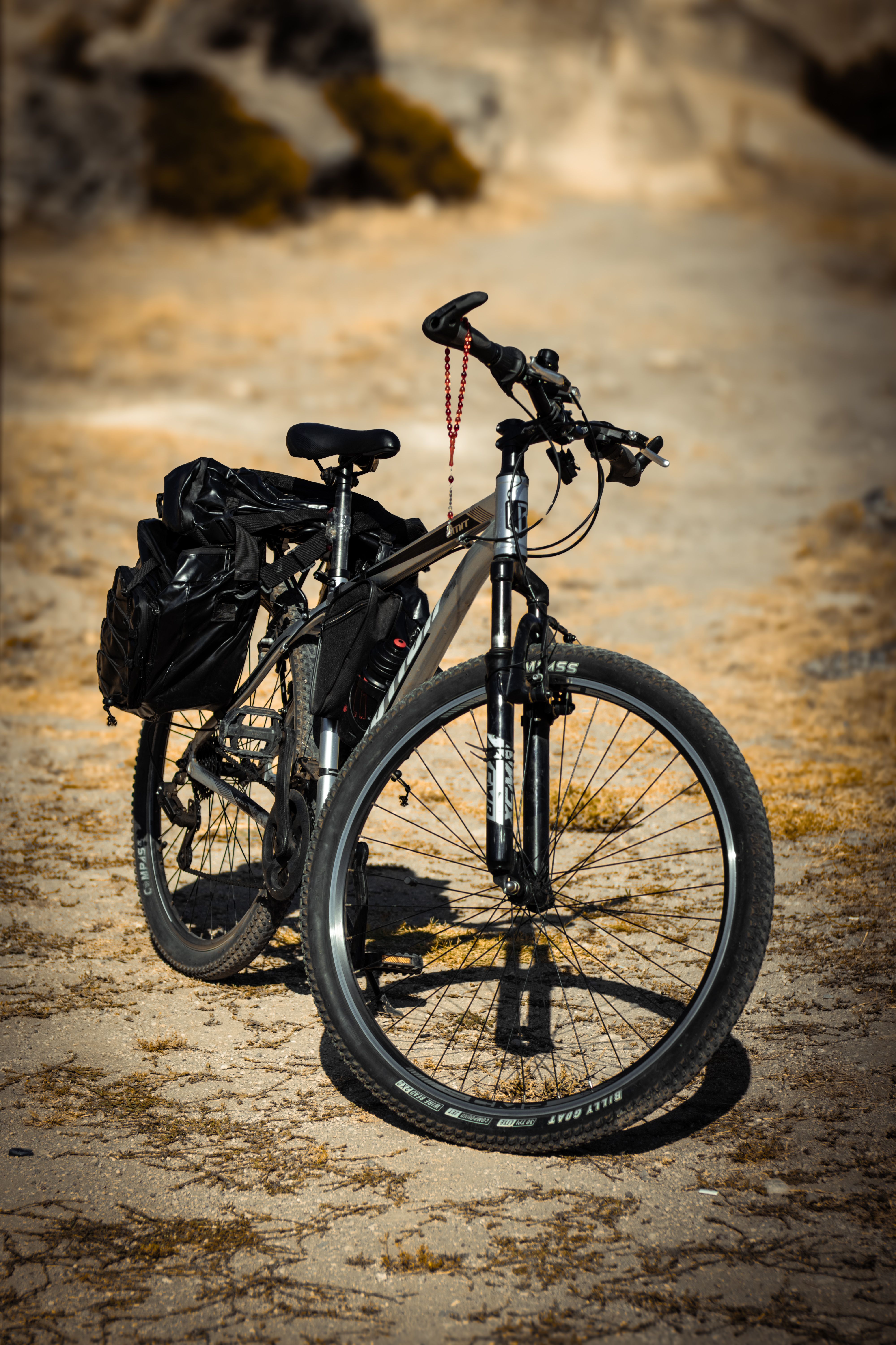 Mountain bike with gear on a rocky surface, perfect for adventure enthusiasts.