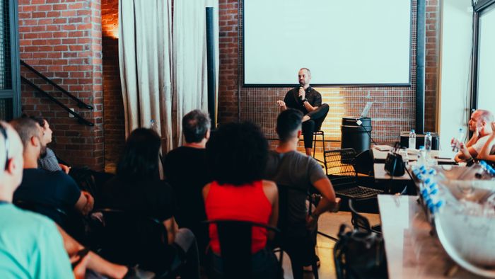 An audience watching a studio talk, photo by Matheus Bertelli on Pexels