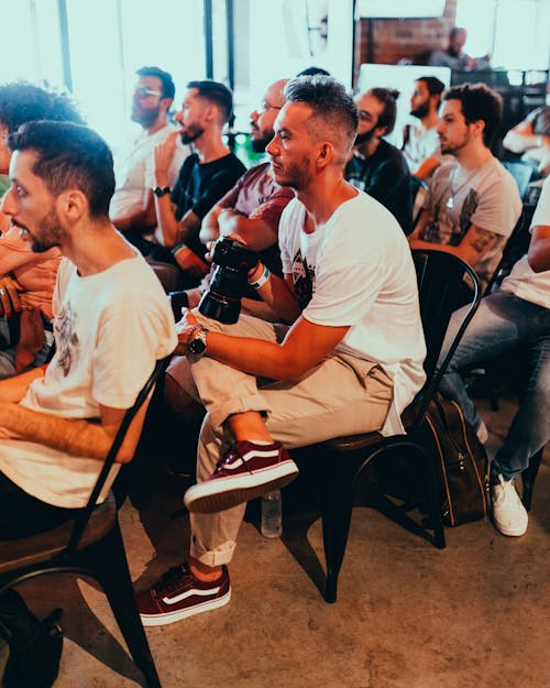 Photo Of People Sitting On Chairs