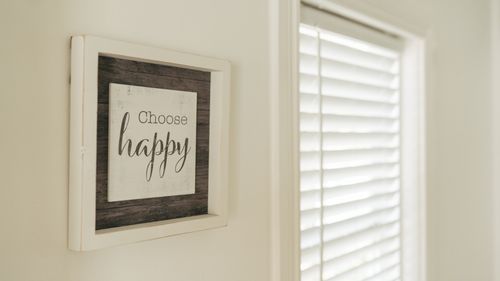 Free Minimalist wall art with uplifting 'Choose happy' quote in bright room. Stock Photo