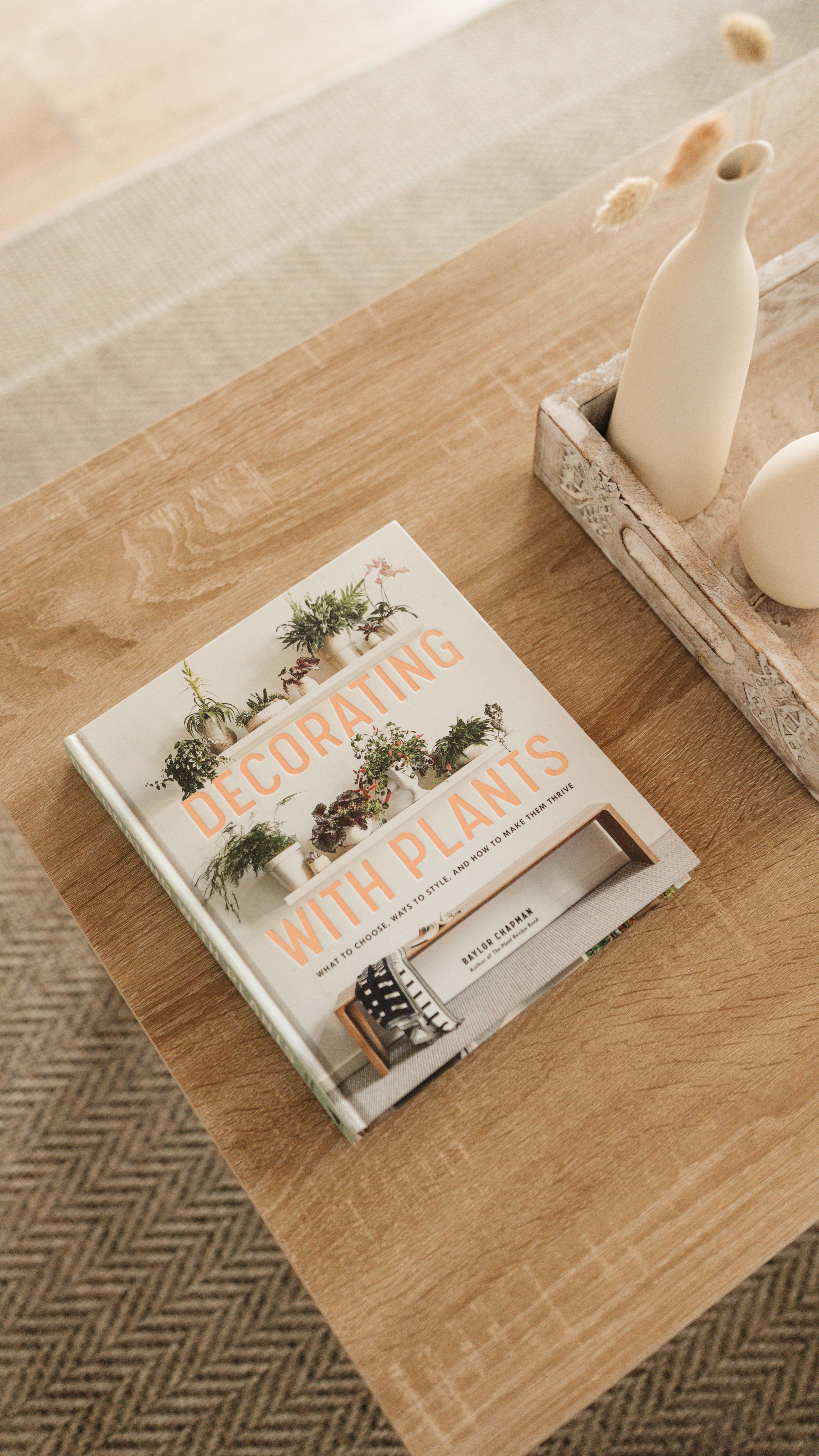 A home living room scene with a book on decorating with plants, exuding minimalist style.. pexels, home, living
