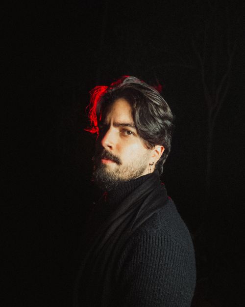 Free A dramatic portrait of a man with red backlighting, enhancing the moody atmosphere. Stock Photo