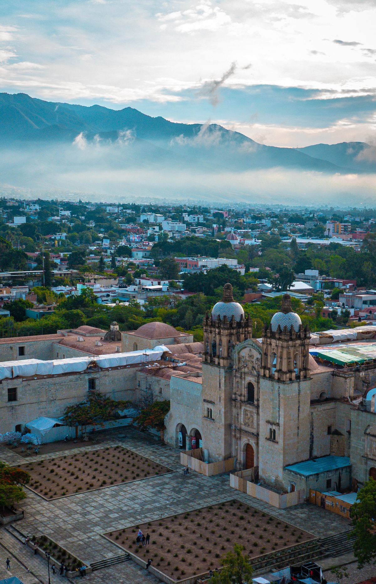 Scenic aerial shot of Oaxaca City with mountains and Santo Domingo Church, Mexico.