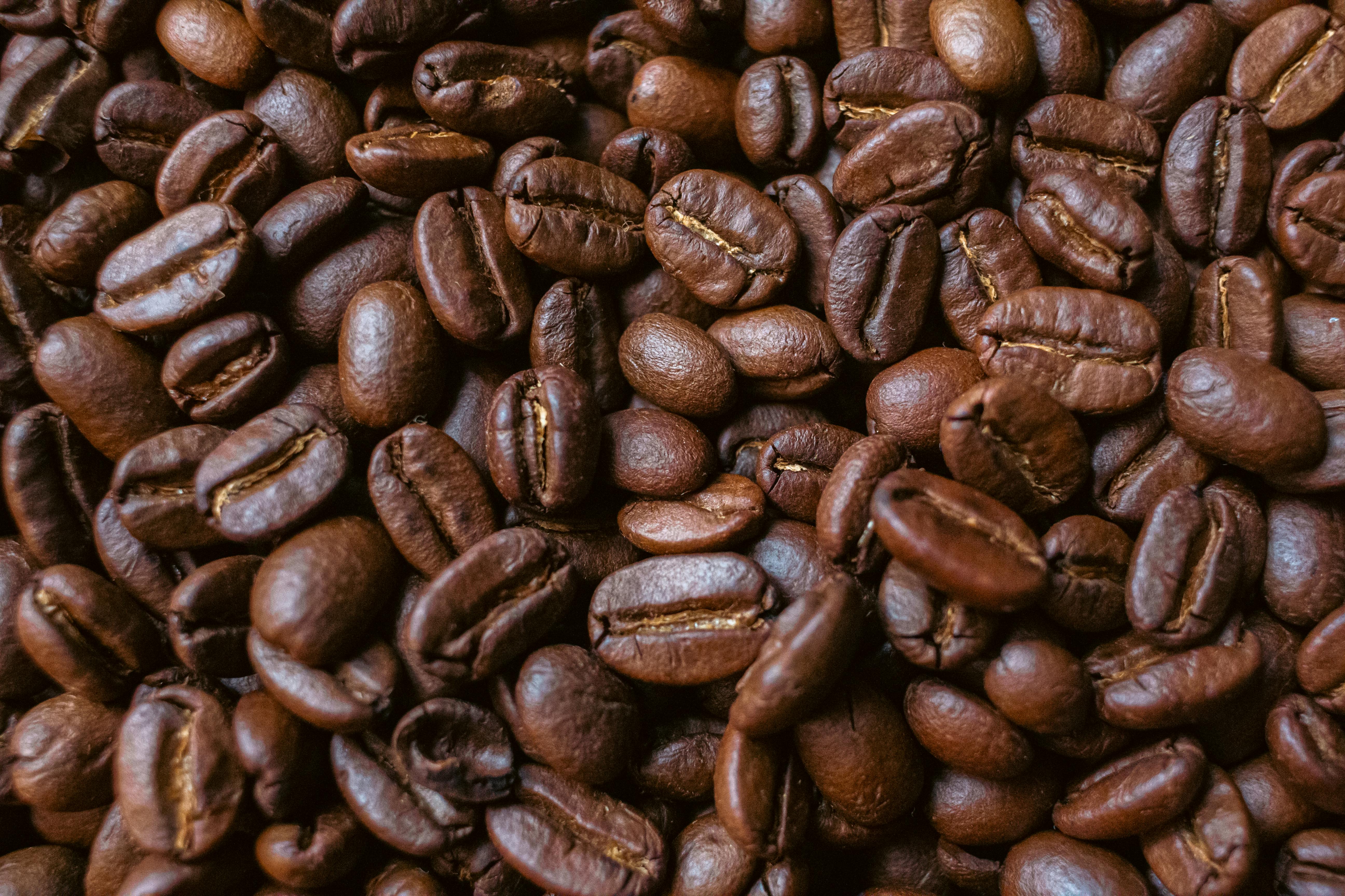 premium vanilla coffee beans for sale - A detailed closeup of aromatic freshly roasted coffee beans, perfect for your coffee-themed projects.