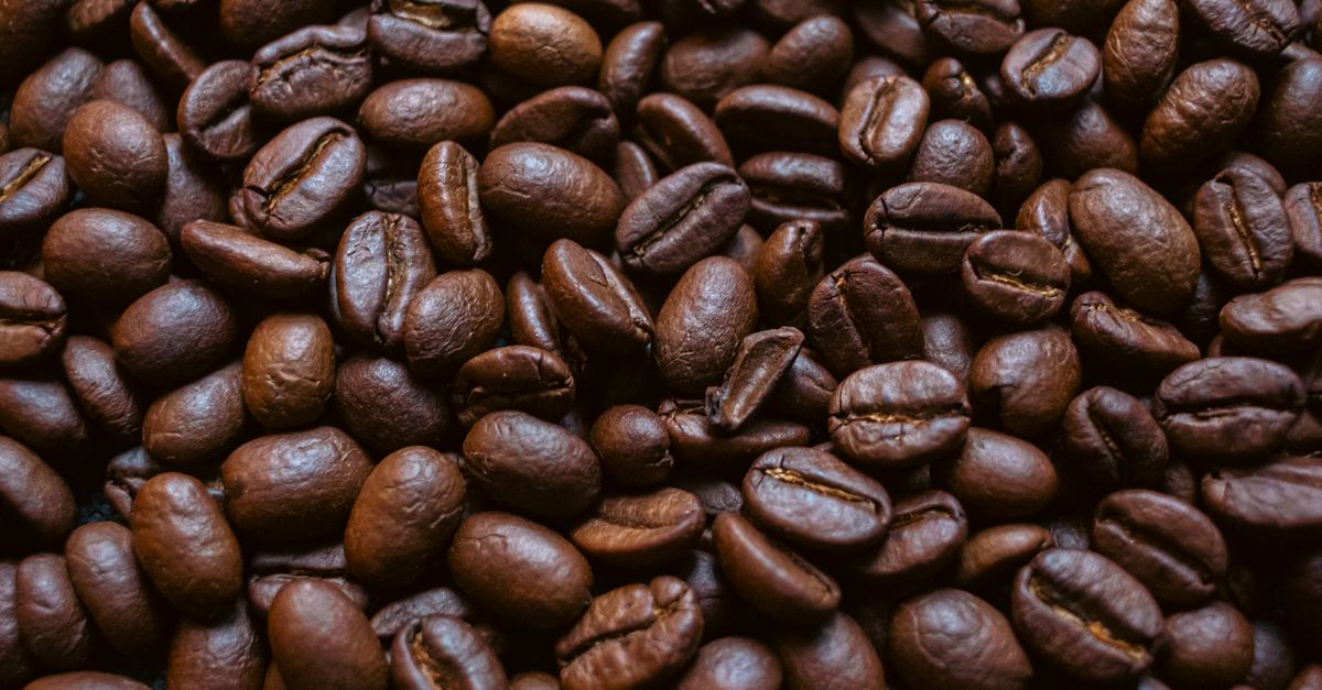 Rich brown roasted coffee beans filling the frame, perfect for coffee enthusiasts.