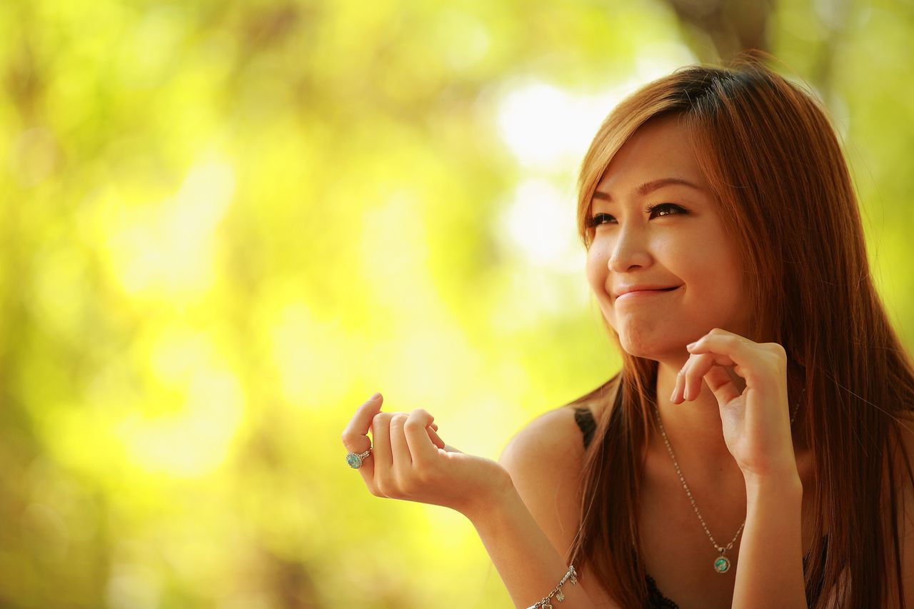 cheerful woman enjoying a sunny day surrounded by vibrant natural ligh