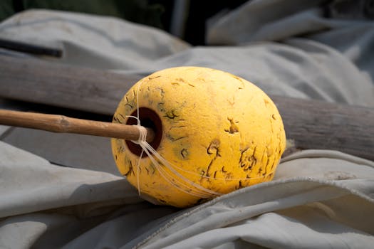 Close-up of a yellow fishing float on a Vietnamese dock, showcasing local craftsmanship.