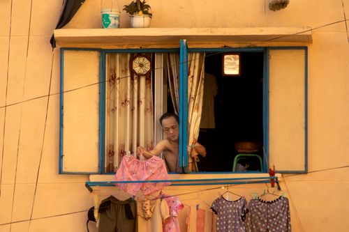 Free Candid image of daily life in Vietnam showing laundry hanging outside a window. Stock Photo