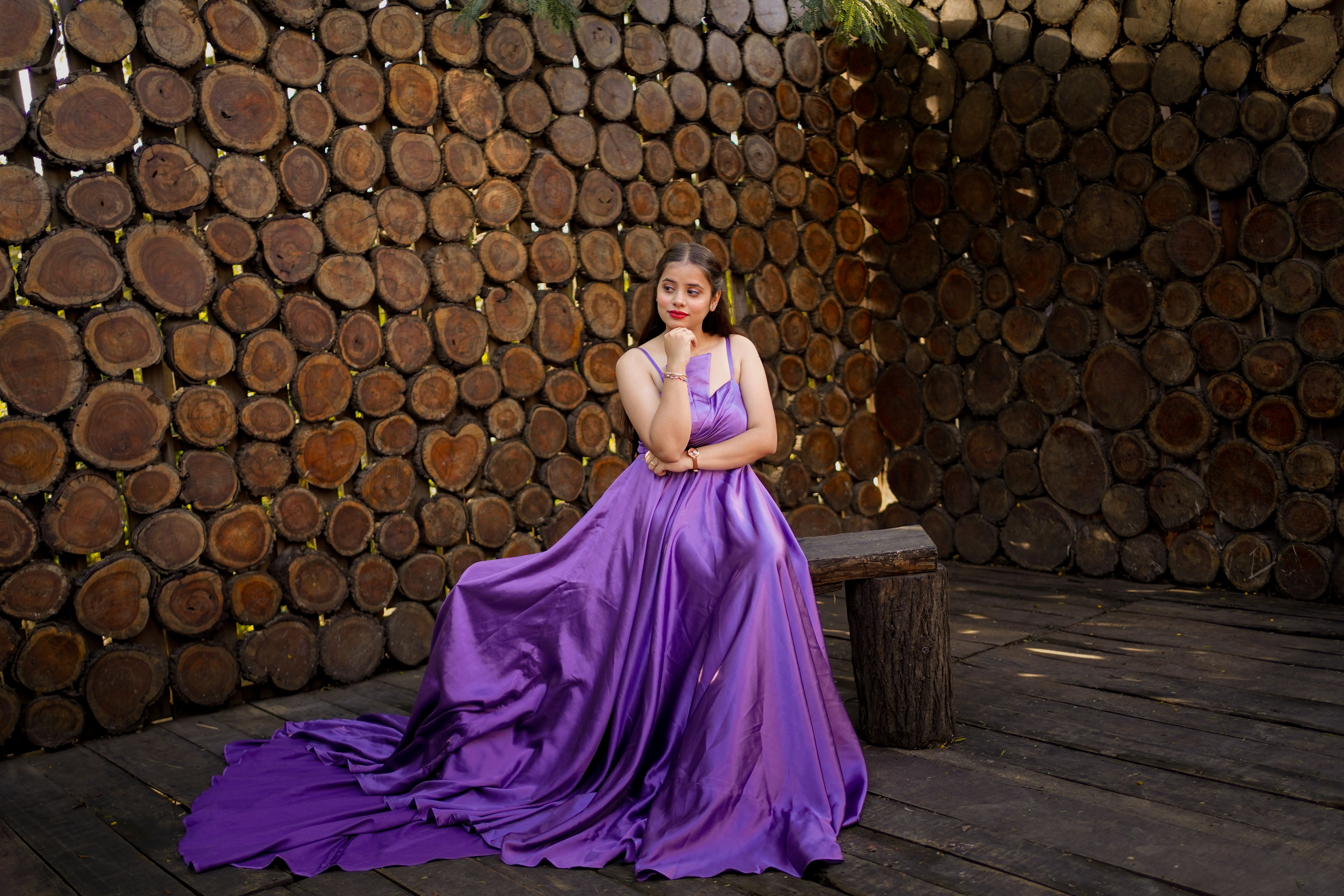 Elegant Woman in Purple Gown against Rustic Wood · Free Stock Photo