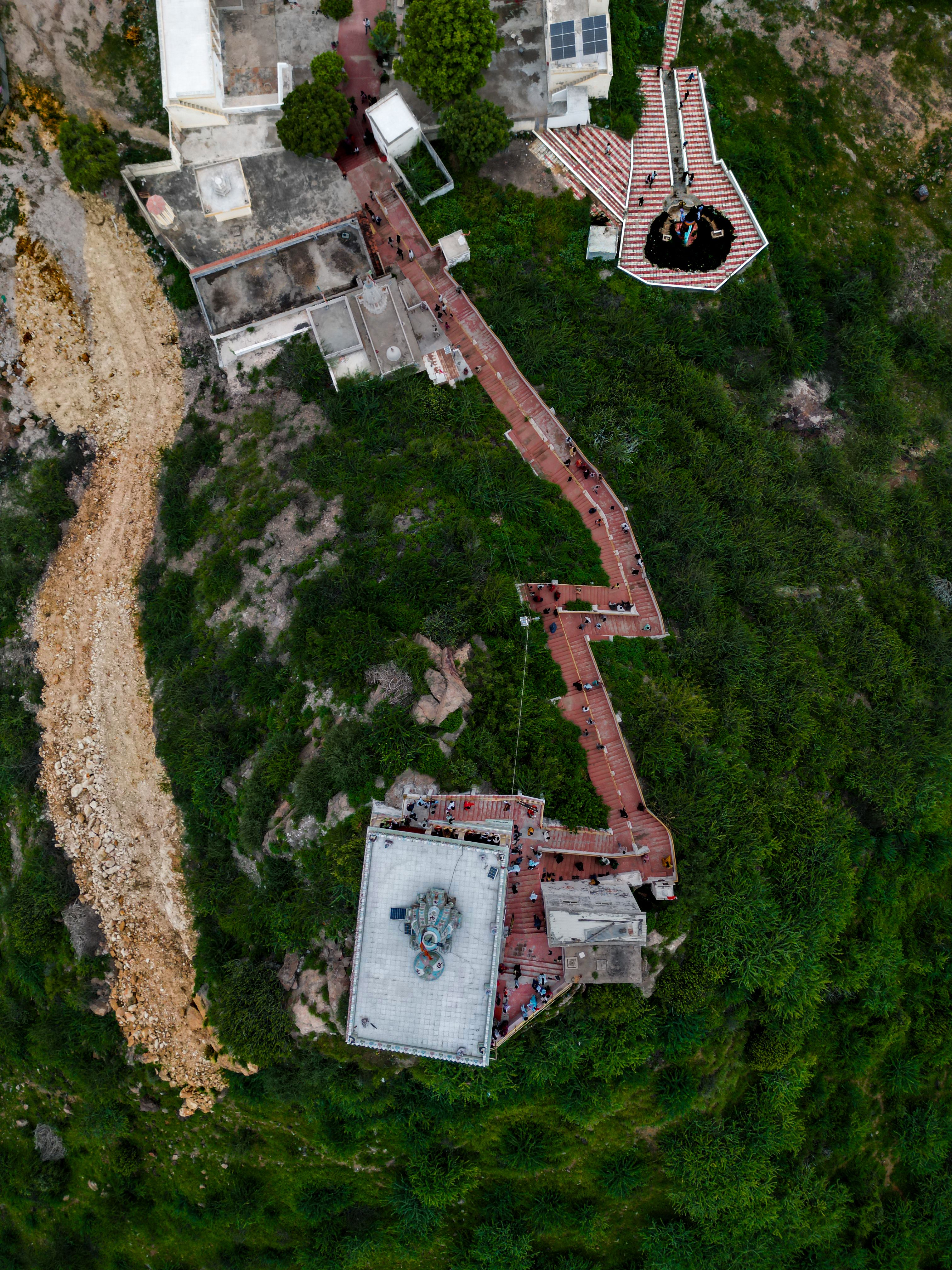 A stunning aerial view of a temple complex in Bhuj, Gujarat, surrounded by lush greenery.