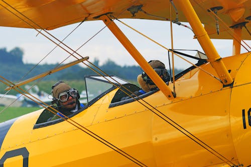 People Riding Yellow Plane