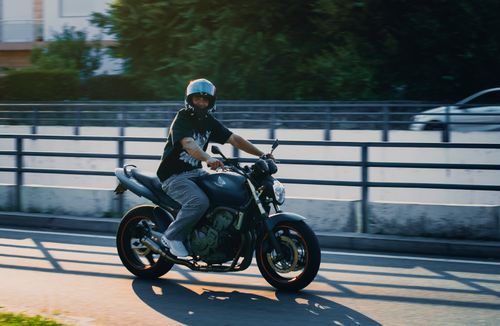 Free A happy motorcyclist riding on a sunny day in Braga, Portugal. Stock Photo