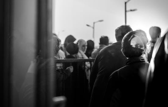 Expressive black and white image capturing a crowd through reflections.