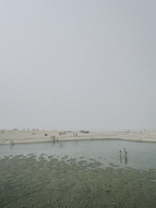 Free Misty beach view in Portugal's Viana do Castelo District with people exploring the shore. Stock Photo