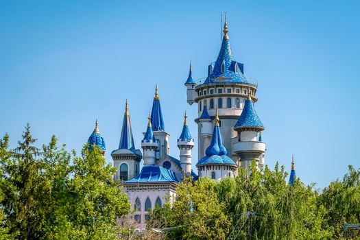 Stunning fairytale castle with blue turrets in Eskişehir, Türkiye, set against a clear blue sky.
