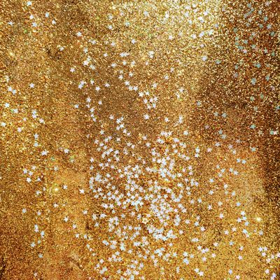 Golden glitter with white stars — photo by Em Hopper on Pexels