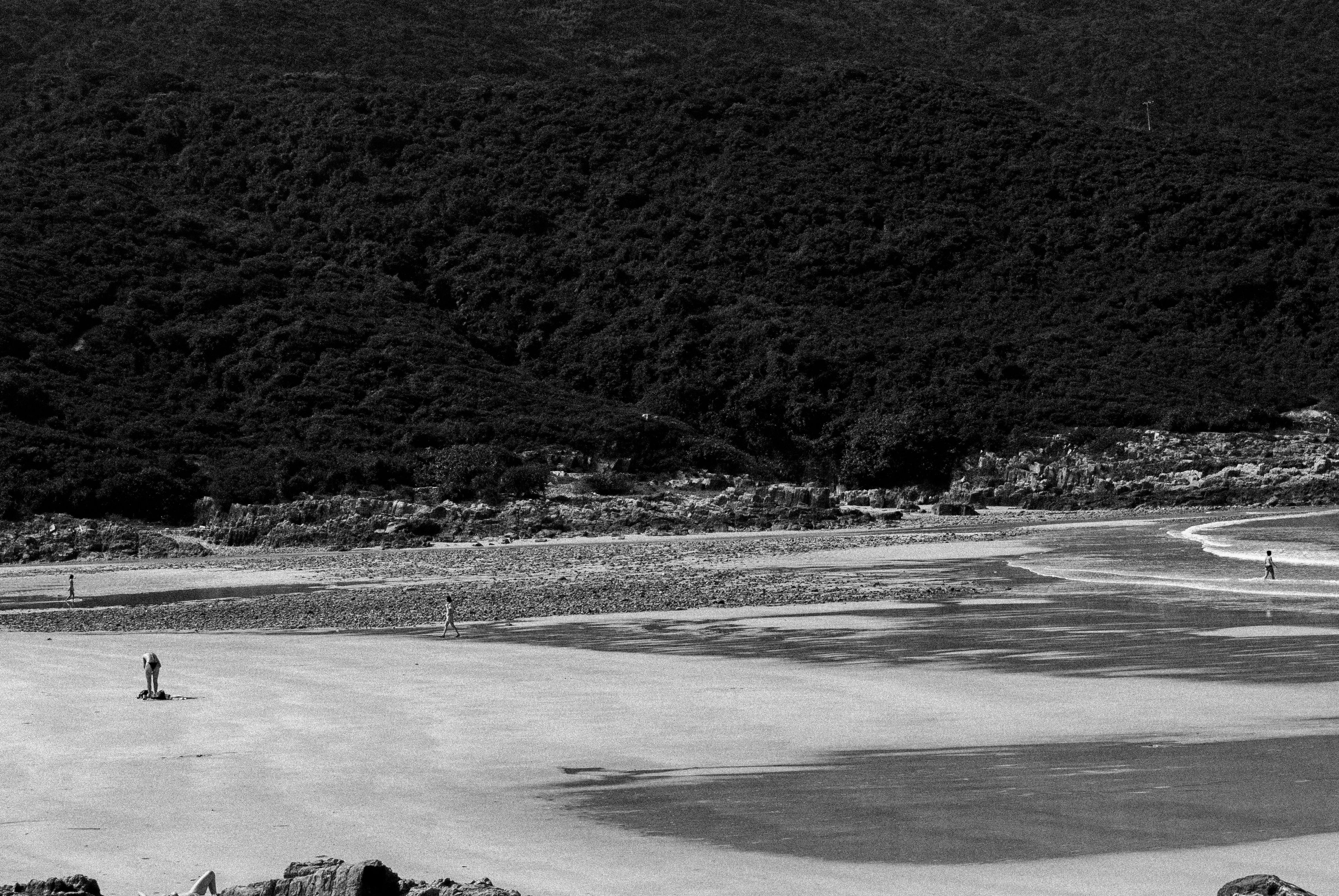 Vast granite landscape with small human figure in last light