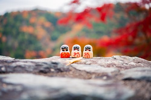 Brown Wooden Figurine on Rock