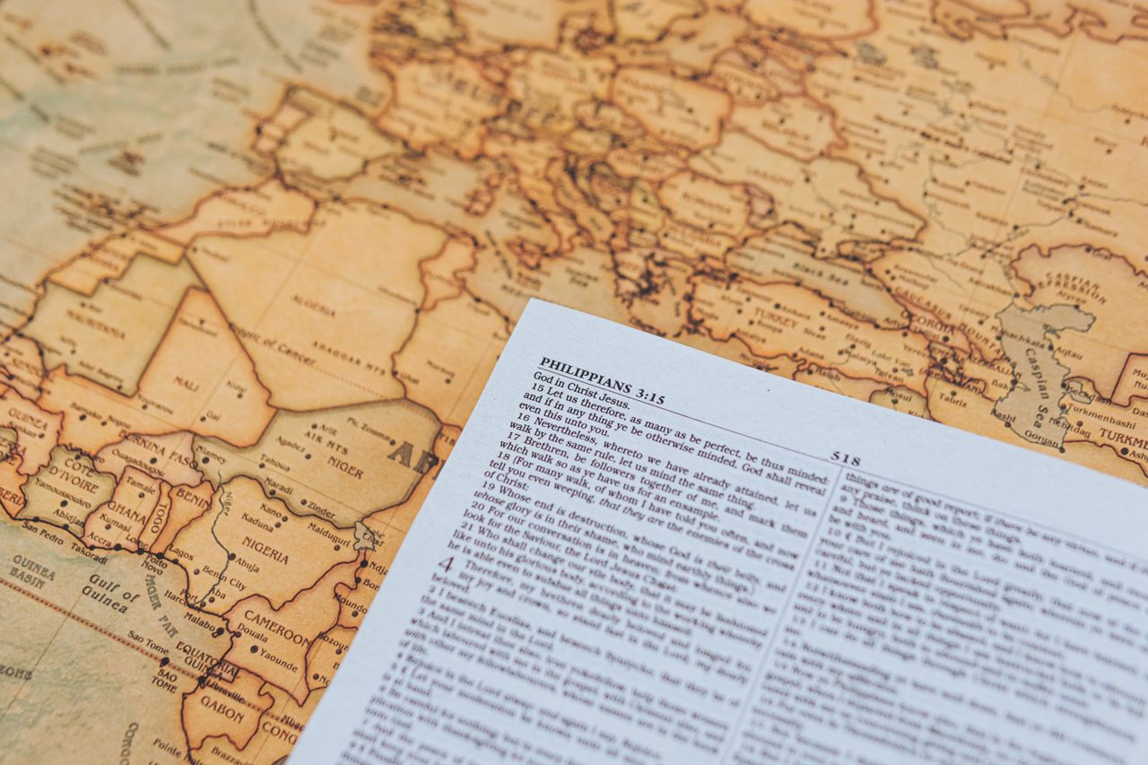 a vintage map featuring a page from the bible with philippians 3 15
