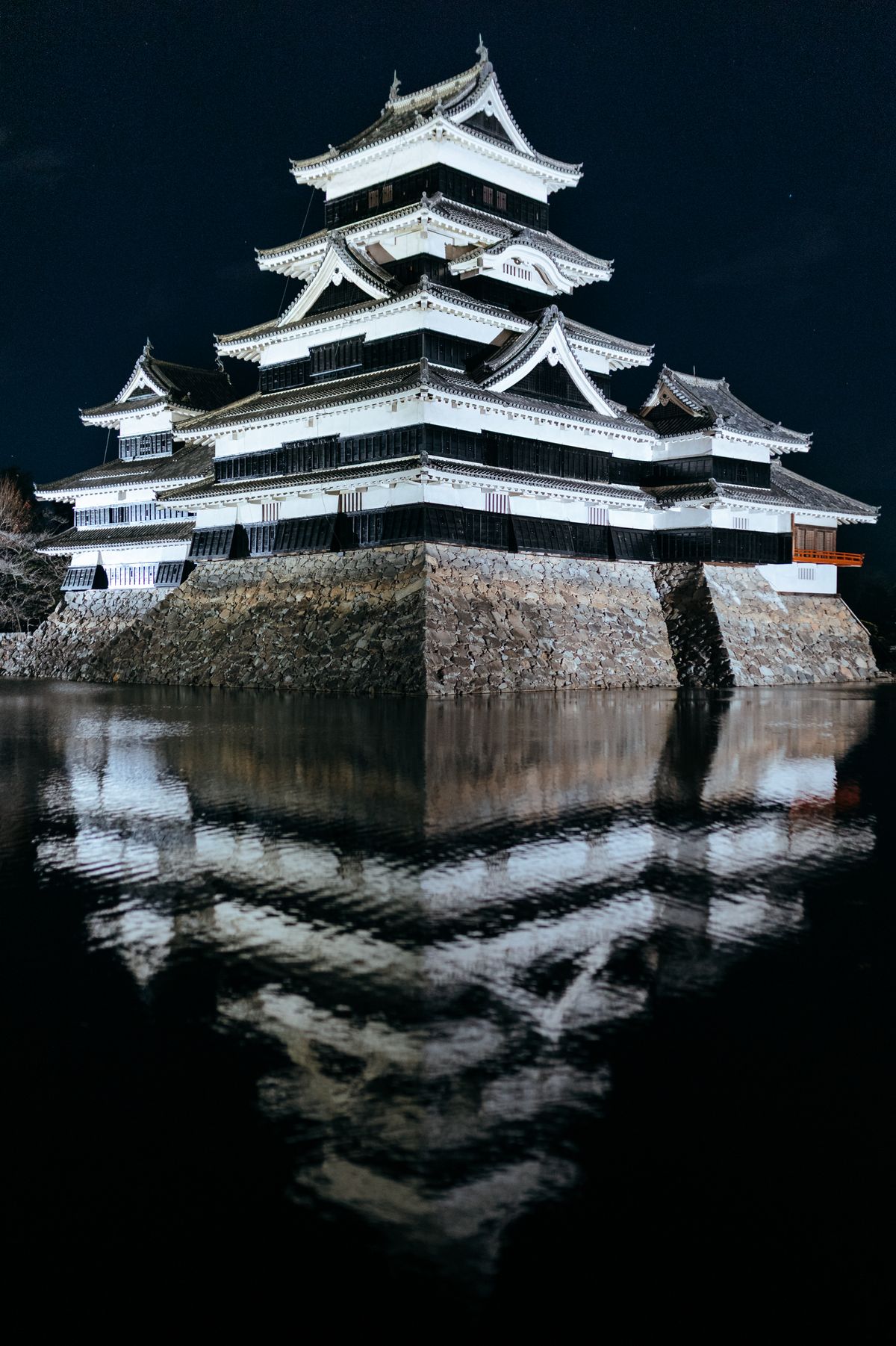Night view of Matsumoto Castle reflected in water, mystical scene