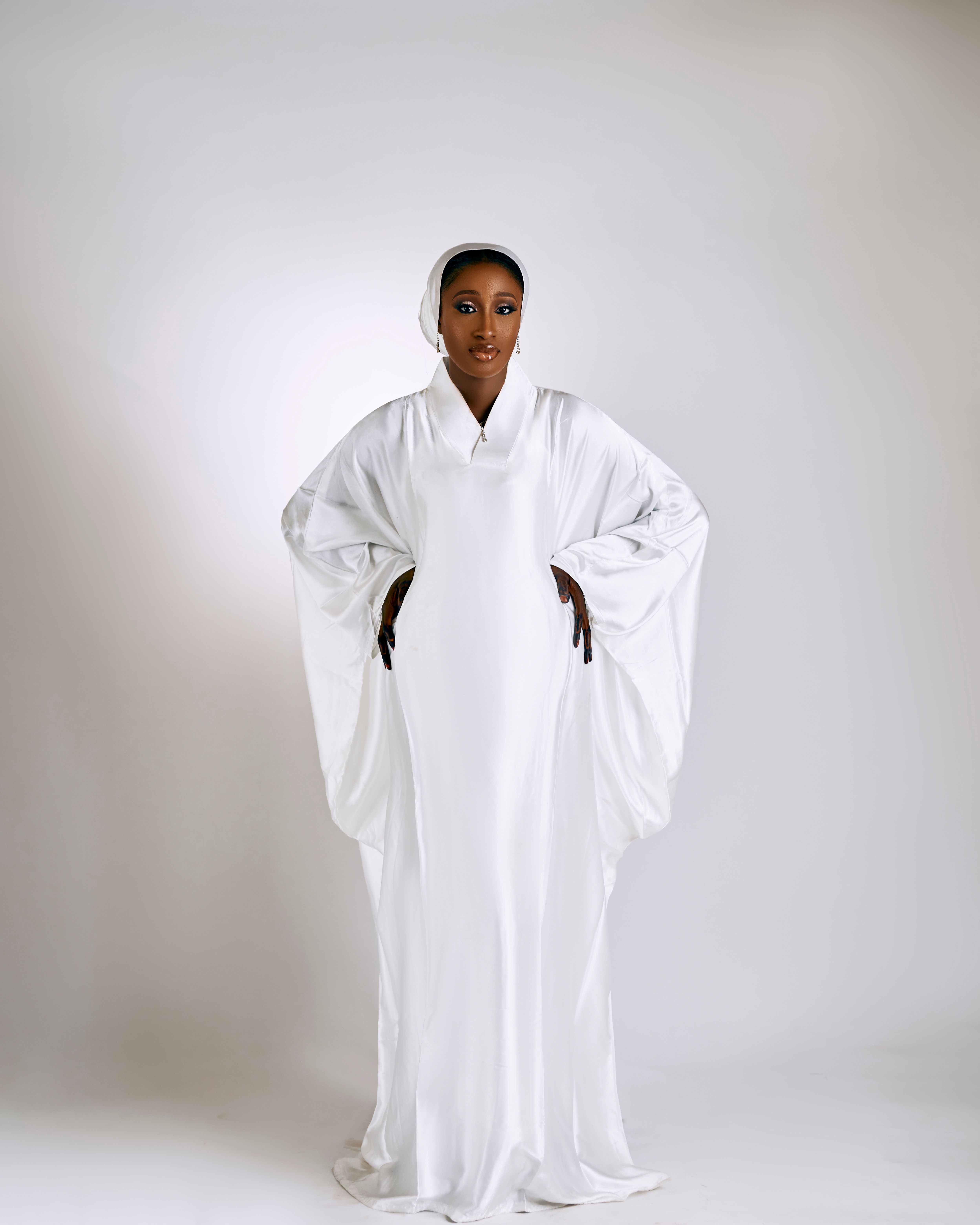 Elegant Woman in Flowing White Attire · Free Stock Photo