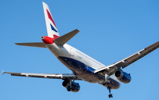 A British Airways Airbus A320 flying under clear blue skies over Manises, Comunidad Valenciana, Spain.