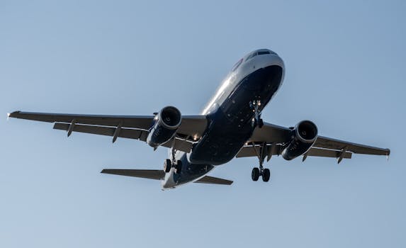 A British Airways Airbus A320 airplane landing at Manises Airport under clear skies.