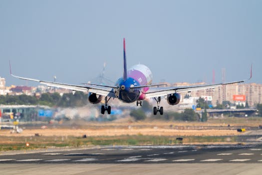 A vibrant airplane lands on the runway at Manises Airport, Valencia, Spain.
