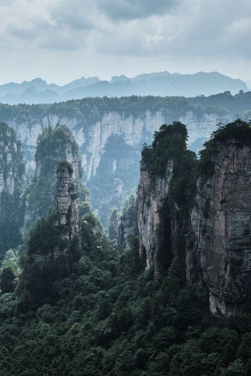 Free Breathtaking view of towering mountain peaks and lush forests in Zhangjiajie, China. Stock Photo