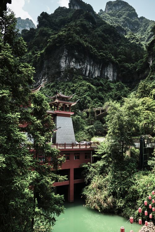 Free Explore stunning traditional Chinese architecture nestled in lush green mountains. Stock Photo