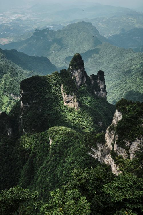 Free A stunning view of green mountains with rugged peaks covered in dense forests. Stock Photo