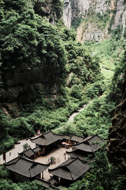 Free A breathtaking aerial view of the Wulong Tianzi City nestled within lush greenery and steep cliffs. Stock Photo
