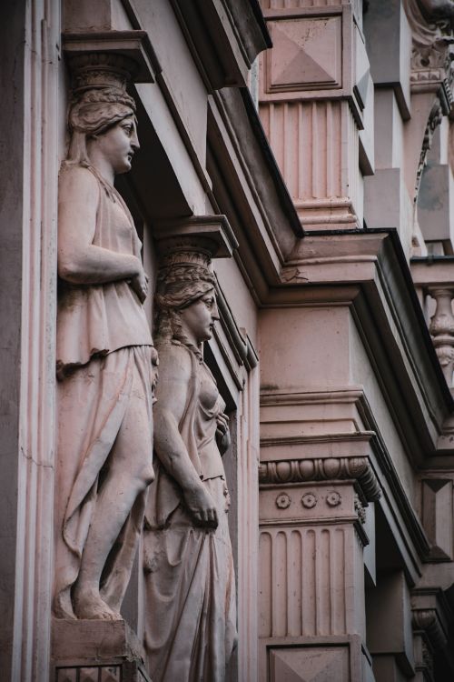 Free Close-up of classical architectural sculptures on an ornate historical building facade. Stock Photo