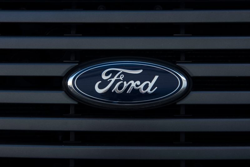 Detailed view of a Ford emblem mounted on a vehicle grille, showcasing modern design.