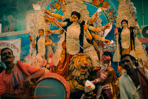 Free Colorful Durga Puja festival scene with devotional figures and vibrant decorations. Stock Photo