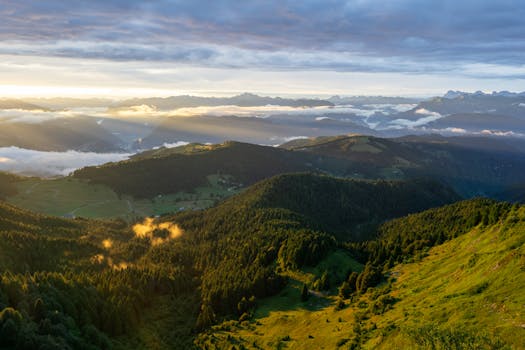 Stunning view of Monte Grappa in Veneto, Italy with lush greenery and sunset skies.