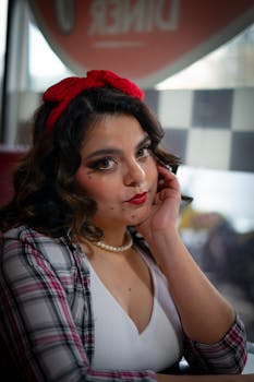 Charming retro portrait of a woman with vintage styling in a classic diner setting.