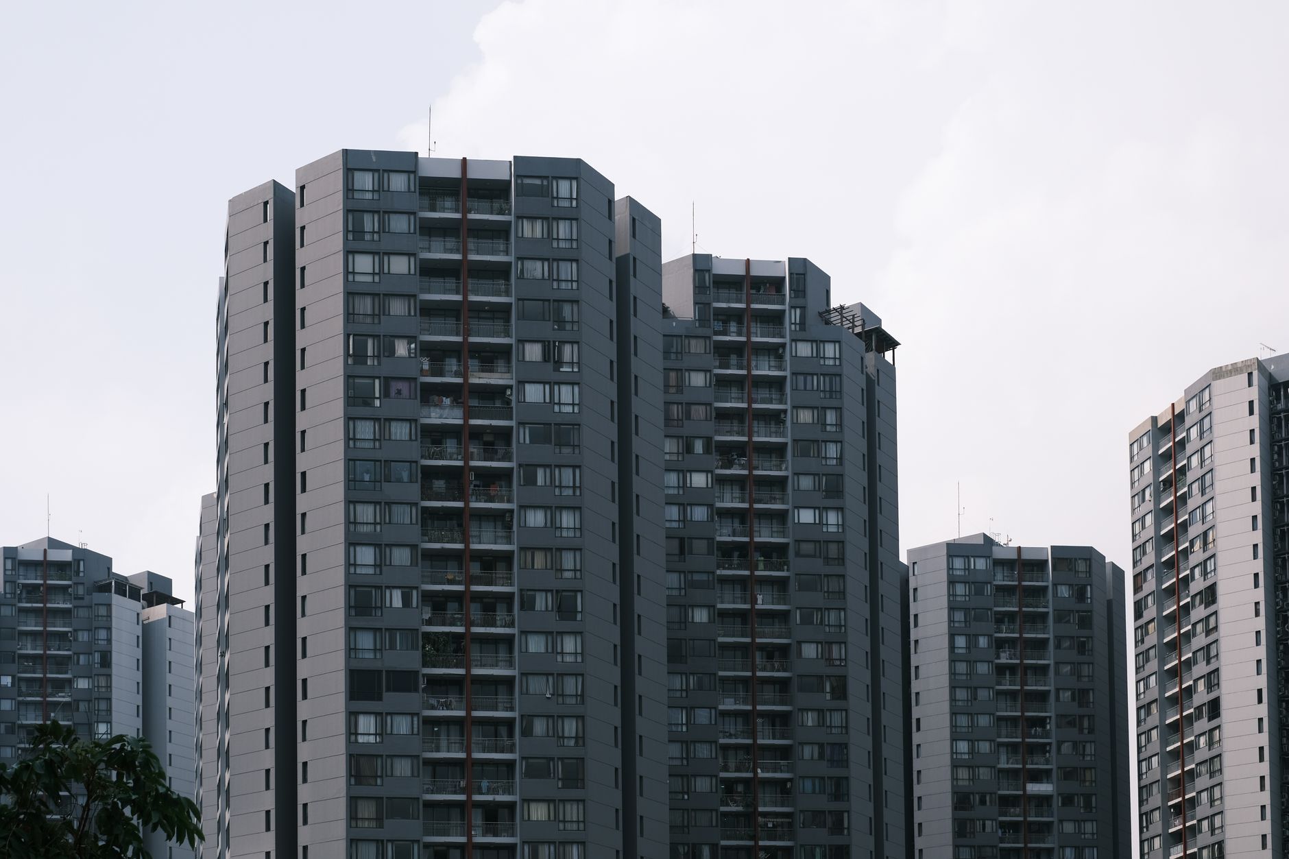 Skyline view of modern high-rise residential buildings against a cloudy sky.