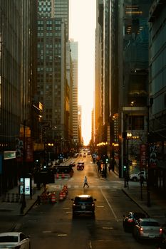 A stunning cityscape at golden hour featuring skyscrapers, traffic, and a bustling street.