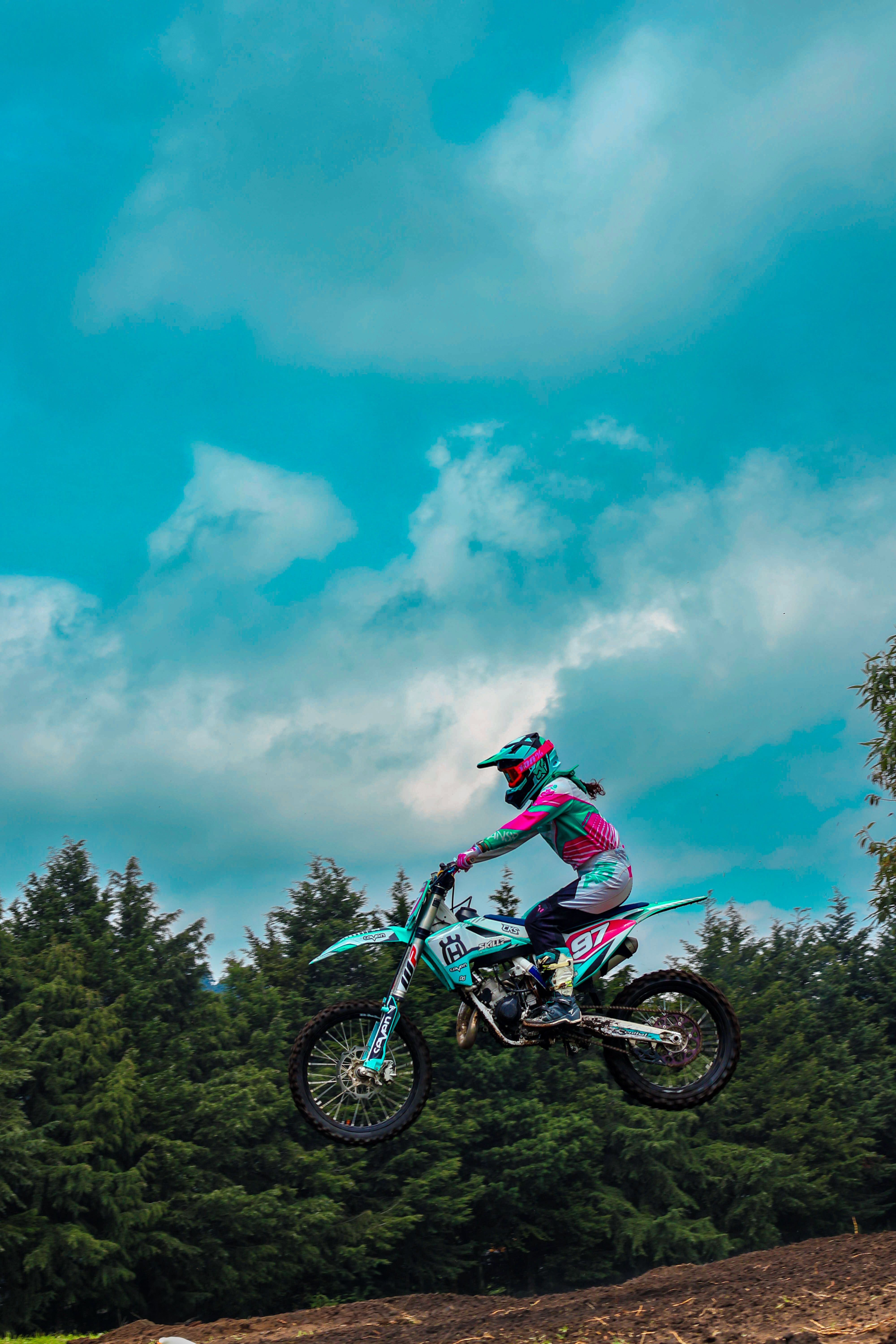 Dirt Bike Rider Jumping Against Blue Sky · Free Stock Photo