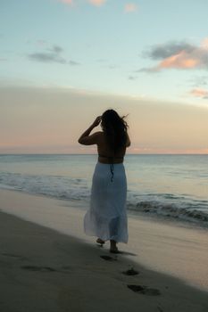 Peaceful evening stroll by the sea with soft pastel sky.