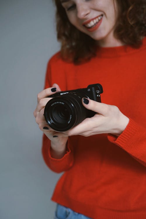 Woman Holding a Black Dslr Camera