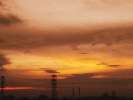 Colorful sunset sky with silhouetted power lines creates a dramatic scene.