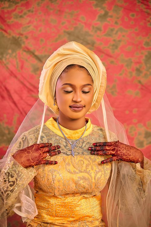 Free Woman in vibrant traditional attire and intricate henna design posing gracefully. Stock Photo