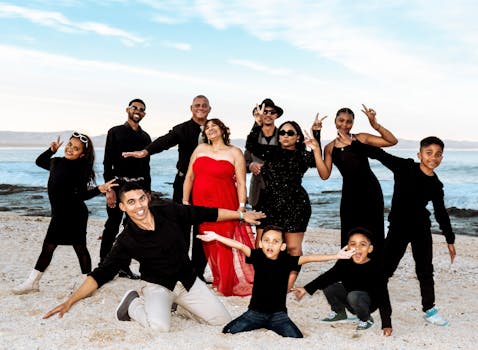 A cheerful family enjoying a fun photo moment on a Cape Town beach.
